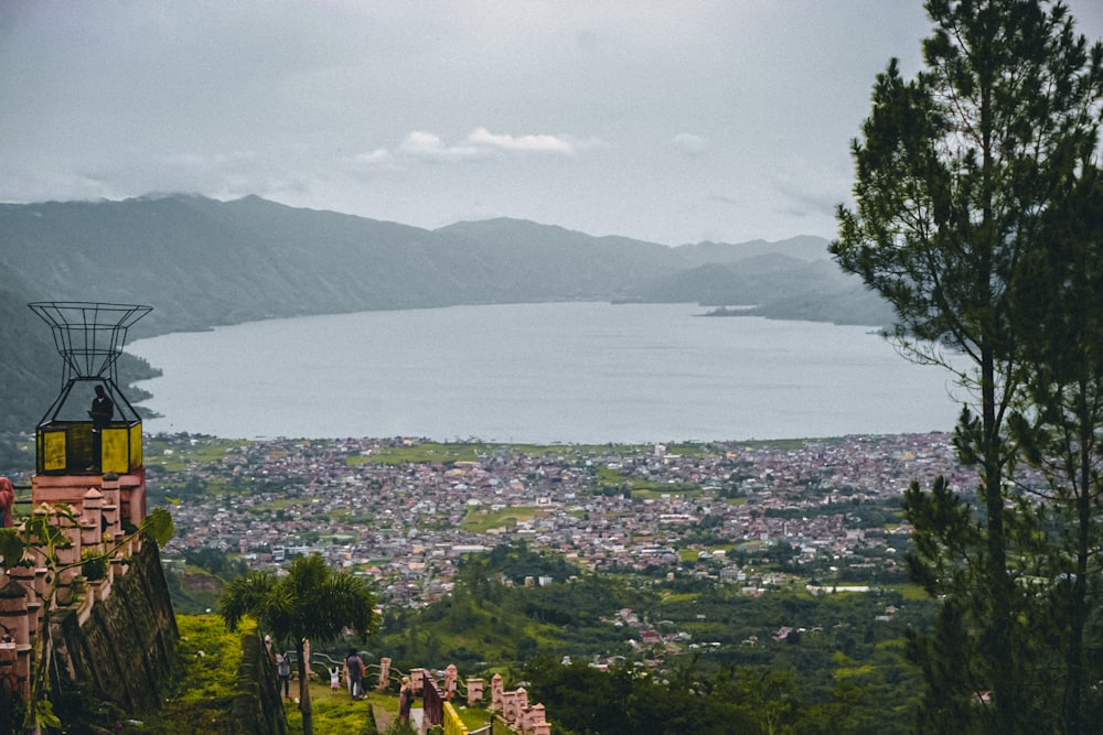 a scenic view of a city and a lake