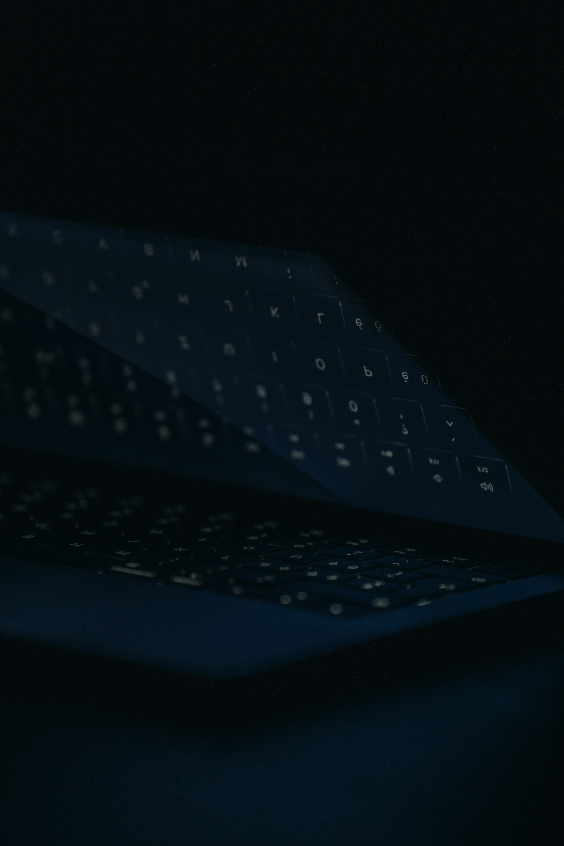 a close up of a computer keyboard in the dark
