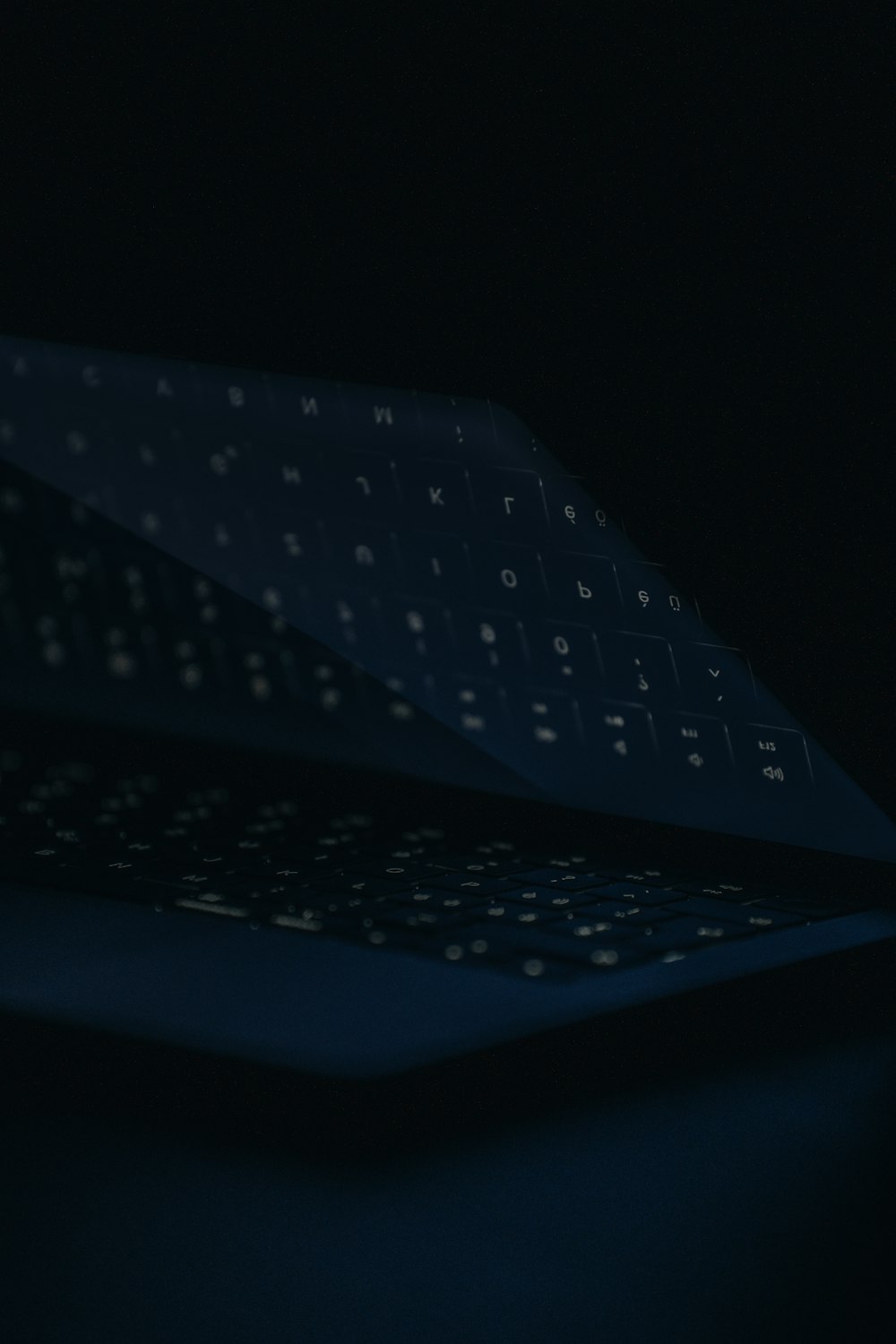 a close up of a computer keyboard in the dark