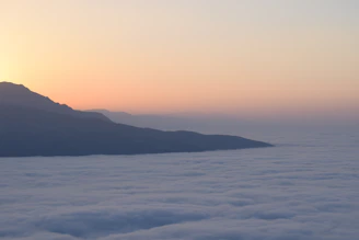 A creative AI video frame capturing a serene sunrise over mountains.
