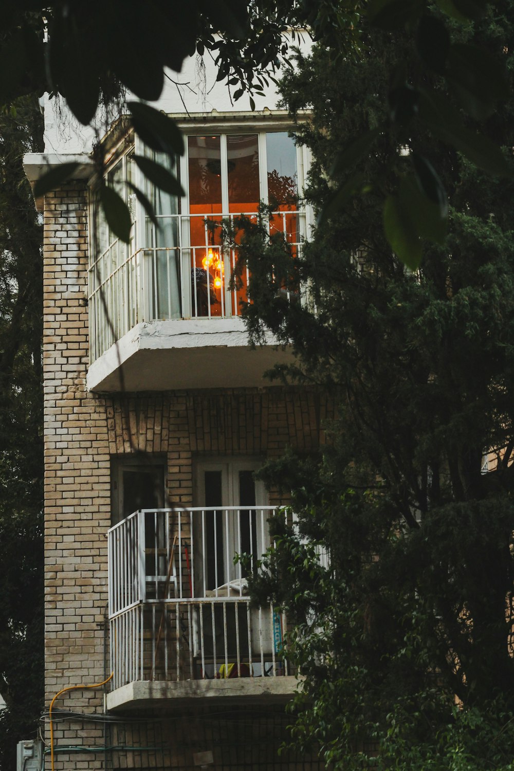 a tall brick building with a white balcony