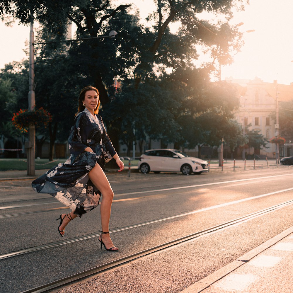 a woman in a dress is running down the street