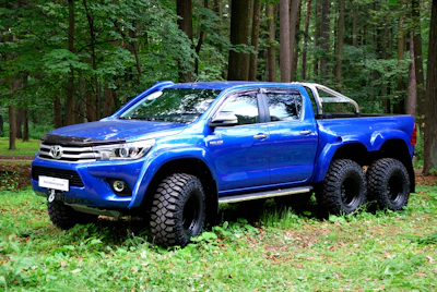 A sturdy Toyota Hilux loaded and ready for oil transport.