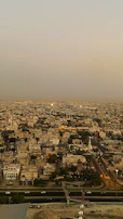 Street view of a busy business district in Karachi during sunset.