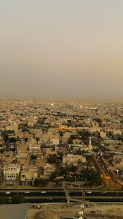 Street view of a busy business district in Karachi during sunset.