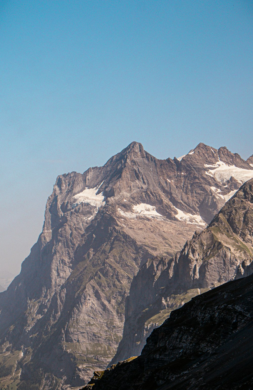 a mountain range with snow capped mountains in the distance