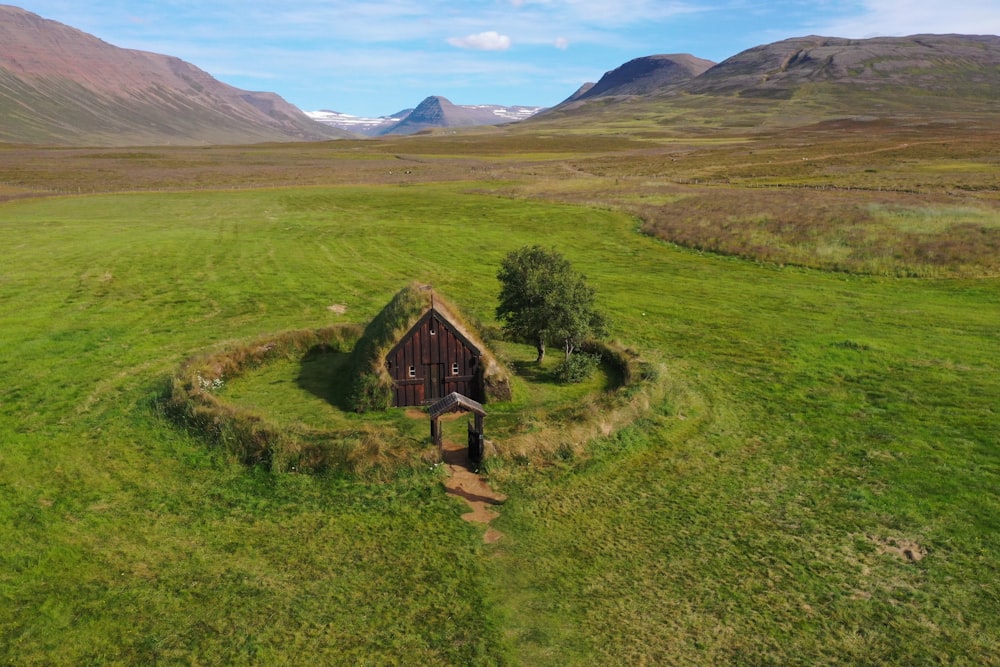 an aerial view of a house in the middle of a field