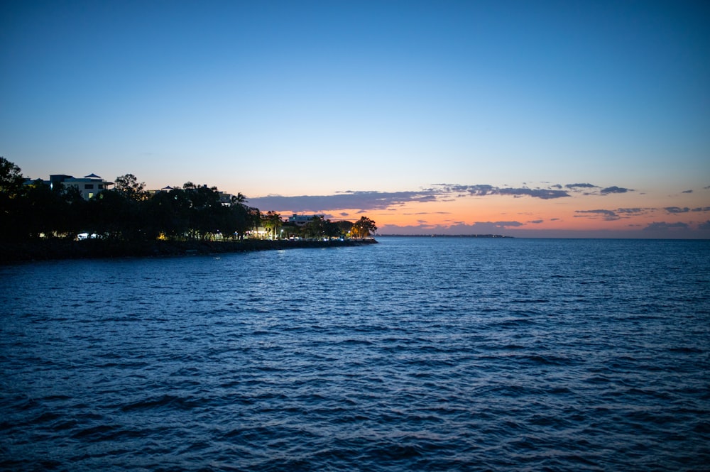 a body of water with a small island in the distance