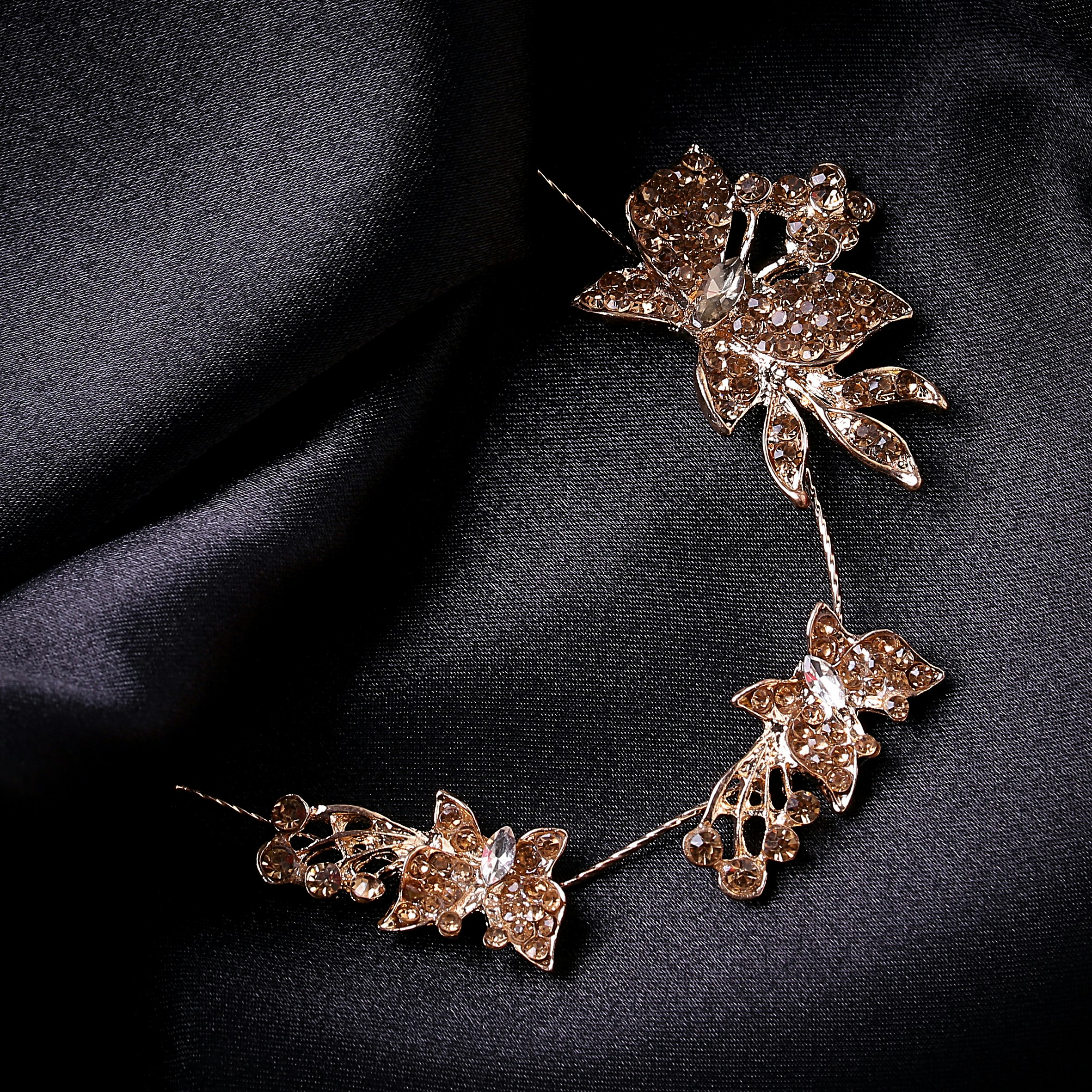 a close up of a brooch with flowers on it