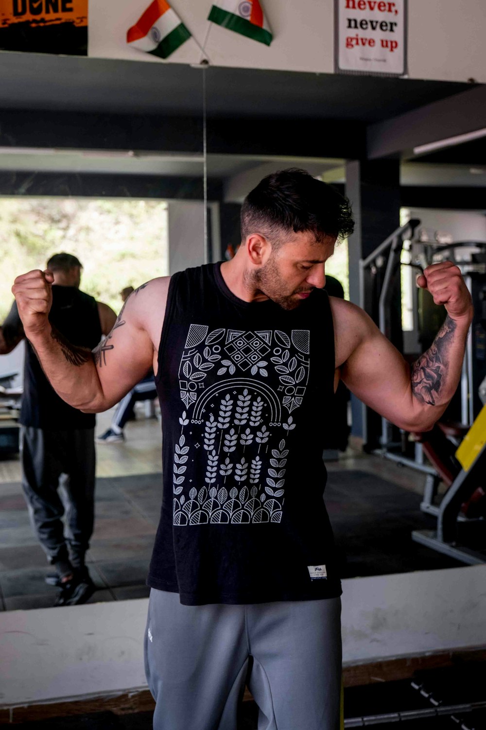 a man with a tattoo on his arm holding a barbell