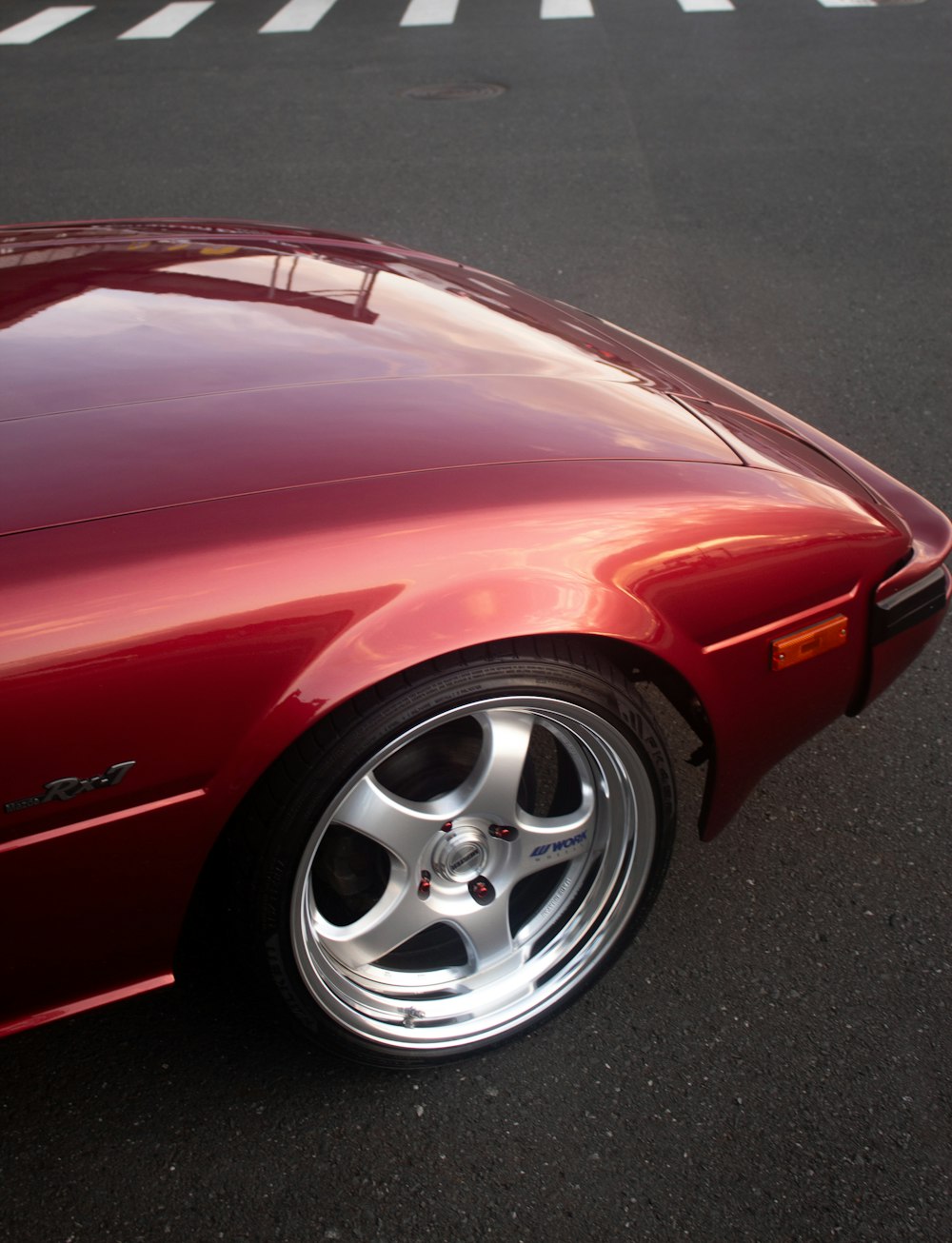 a red sports car parked in a parking lot