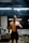 a shirtless man with a camera in a gym