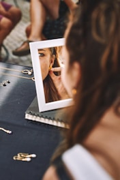 a woman is trying her earings