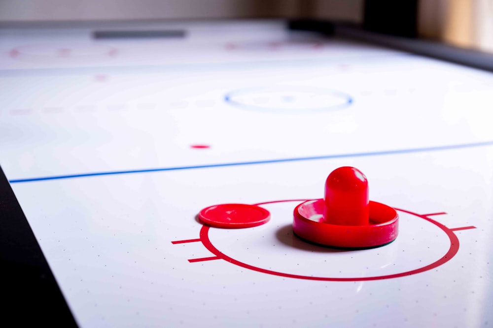 a close up of a hockey rink with a red puck