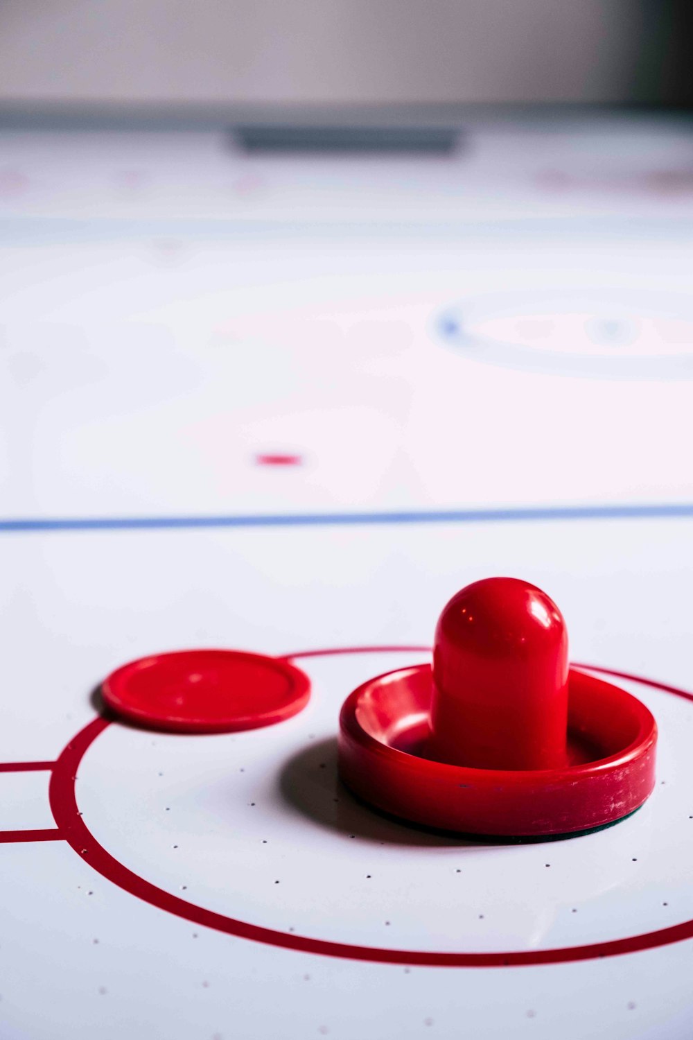 a close up of a hockey rink with a red puck