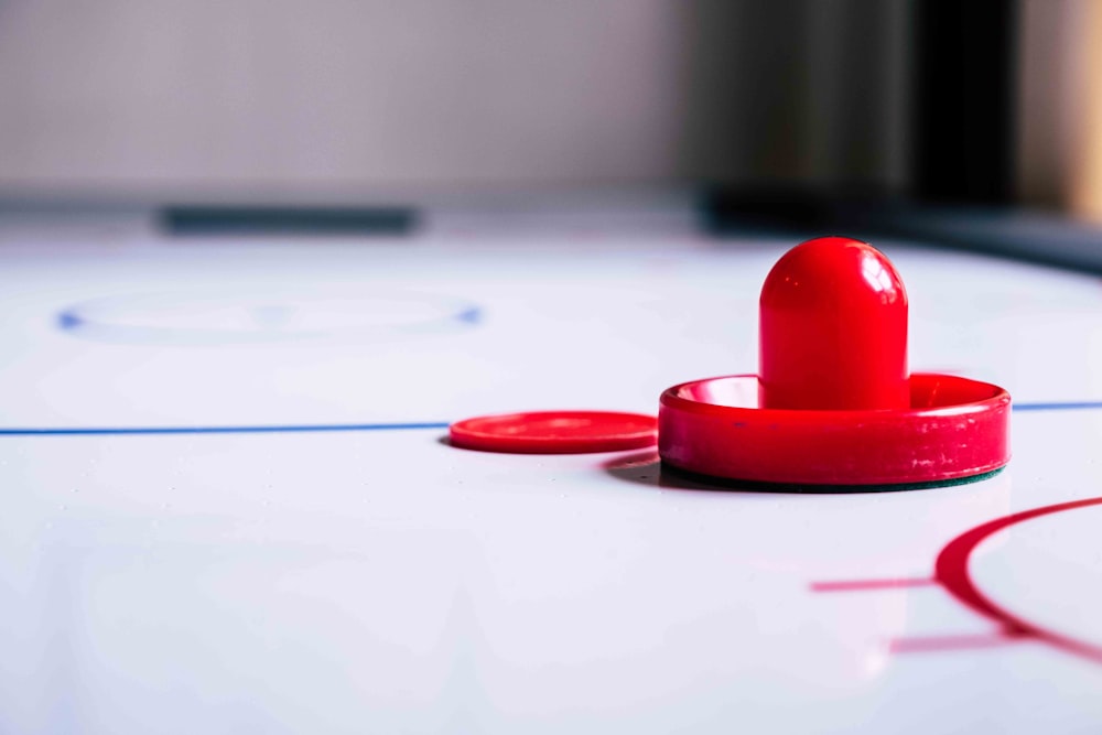 a close up of a hockey rink with a red puck