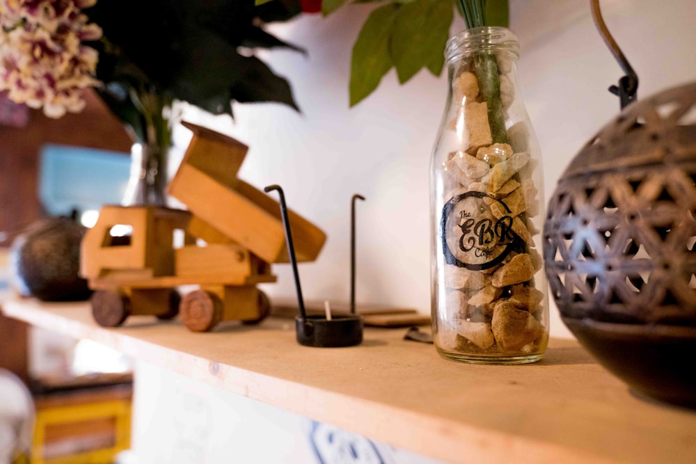 a vase filled with flowers sitting on top of a wooden shelf