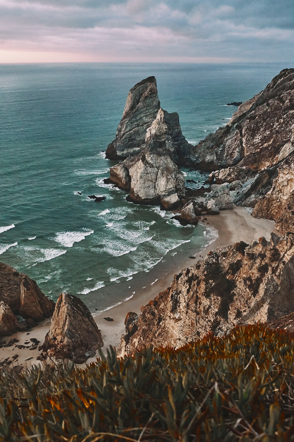 a view of the ocean from the top of a hill