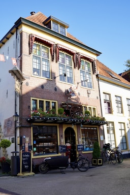 A charming brick storefront in historic downtown Asheville with large display windows.