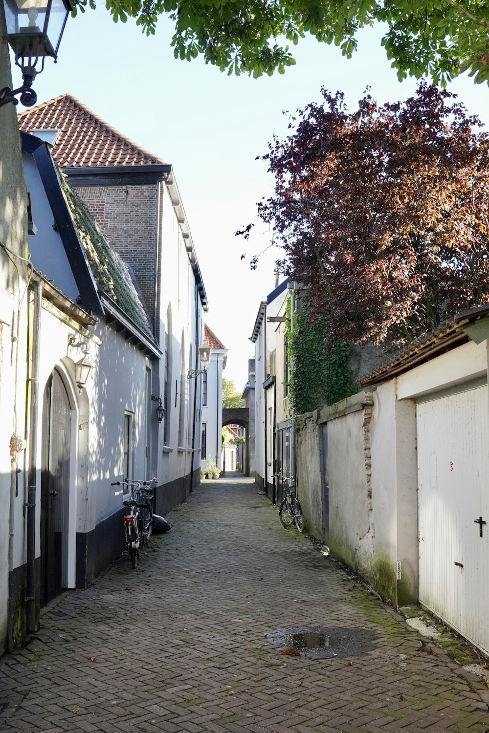 a cobblestone street lined with white buildings