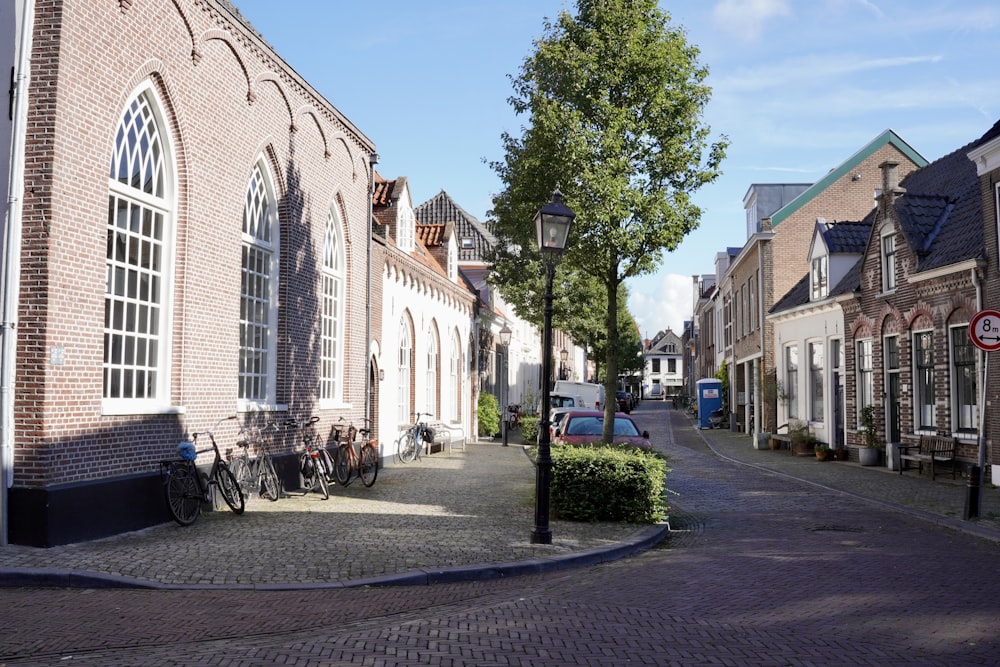 a cobblestone street lined with parked bicycles