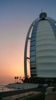 The sparkling Burj Al Arab seen from the water during a peaceful sunset cruise.