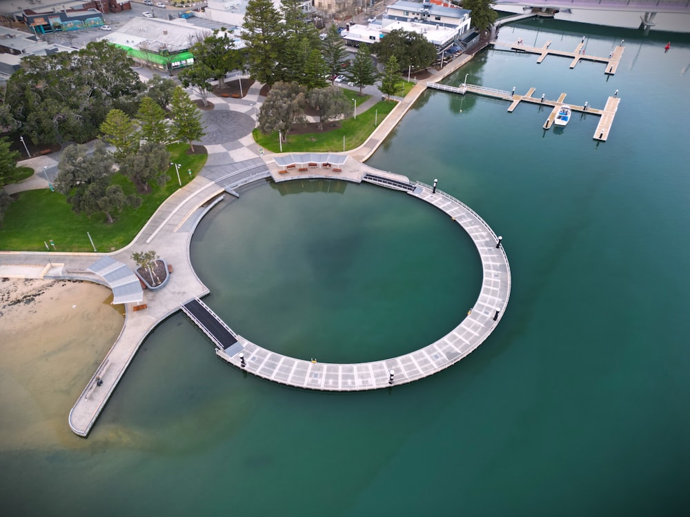 an aerial view of a pier in the middle of a body of water