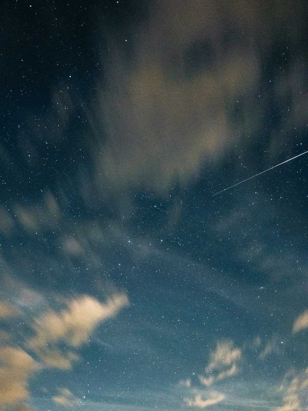 a plane flying through the night sky with stars