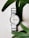 A smiling customer wearing a Frost Fern watch, showcasing its style.