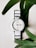 A smiling customer wearing a Frost Fern watch, showcasing its style.