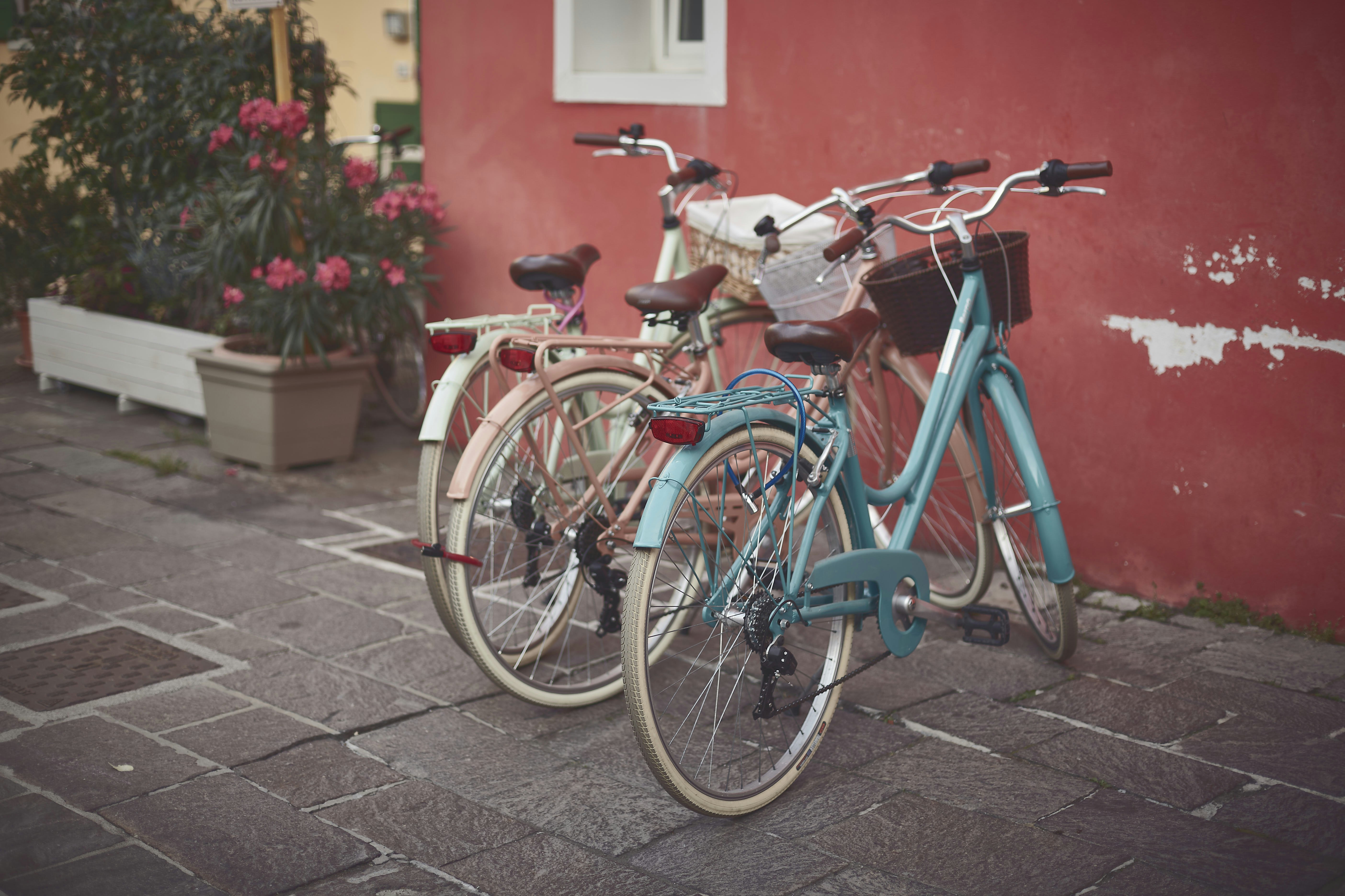a couple of bikes parked next to a red building