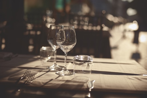 a table topped with two glasses of wine