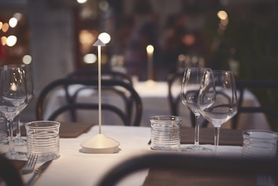 Elegant glassware set reflecting natural light on a dining table.
