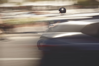 A student weaving through a busy campus quad on a sleek black electric scooter, motion blur capturing speed.