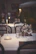 Elegant dining setup on deck with fine wines and caviar under twinkling stars.
