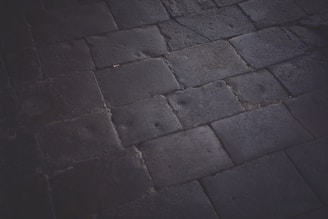 Close-up of a smooth, elegant stone driveway with clean lines and subtle lighting.