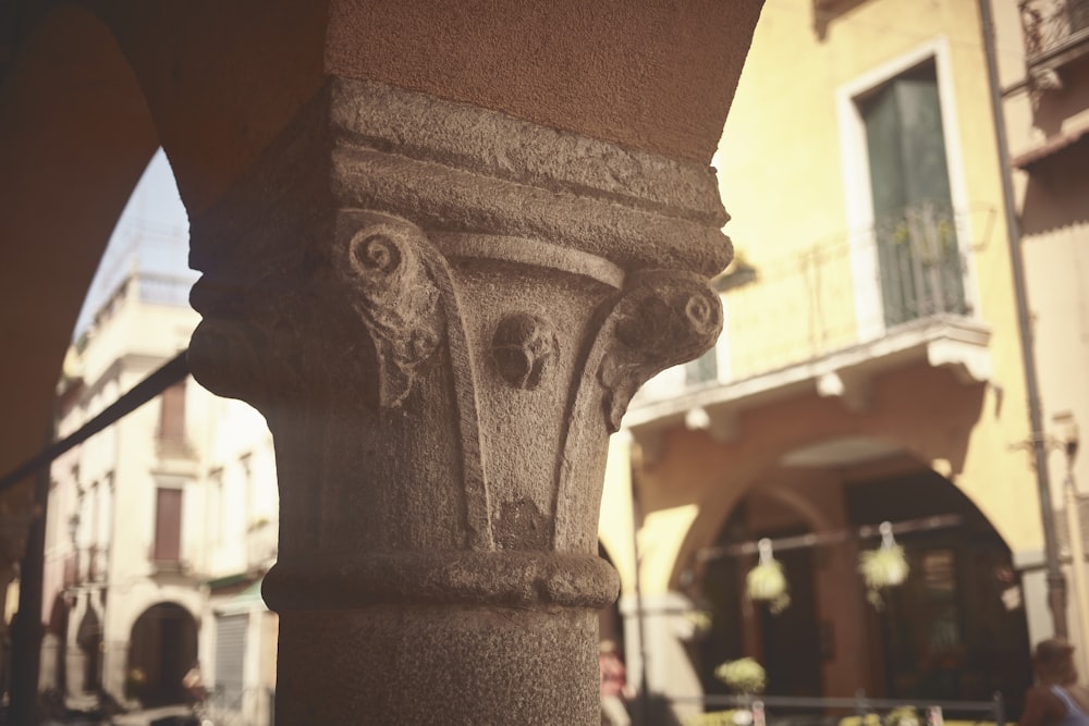 a close up of a stone pillar in a city