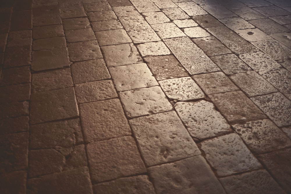 a brick floor with a light shining on it