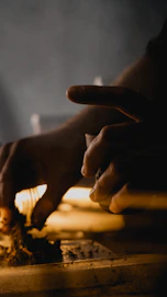 Artisan hands shaping resin art with soft natural light highlighting the subtle beige and white tones.