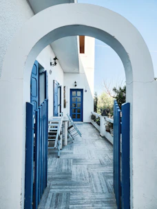 A bright blue-toned veranda bathed in natural light, showcasing elegant aluminum framing.