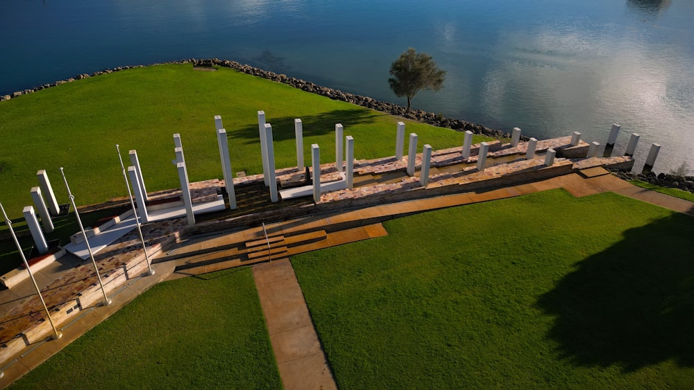 an aerial view of a park with a lake in the background