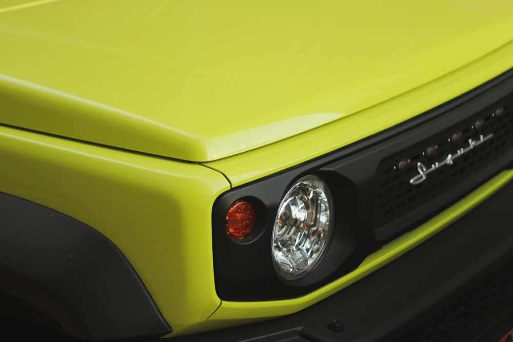 a close up of the front of a yellow truck