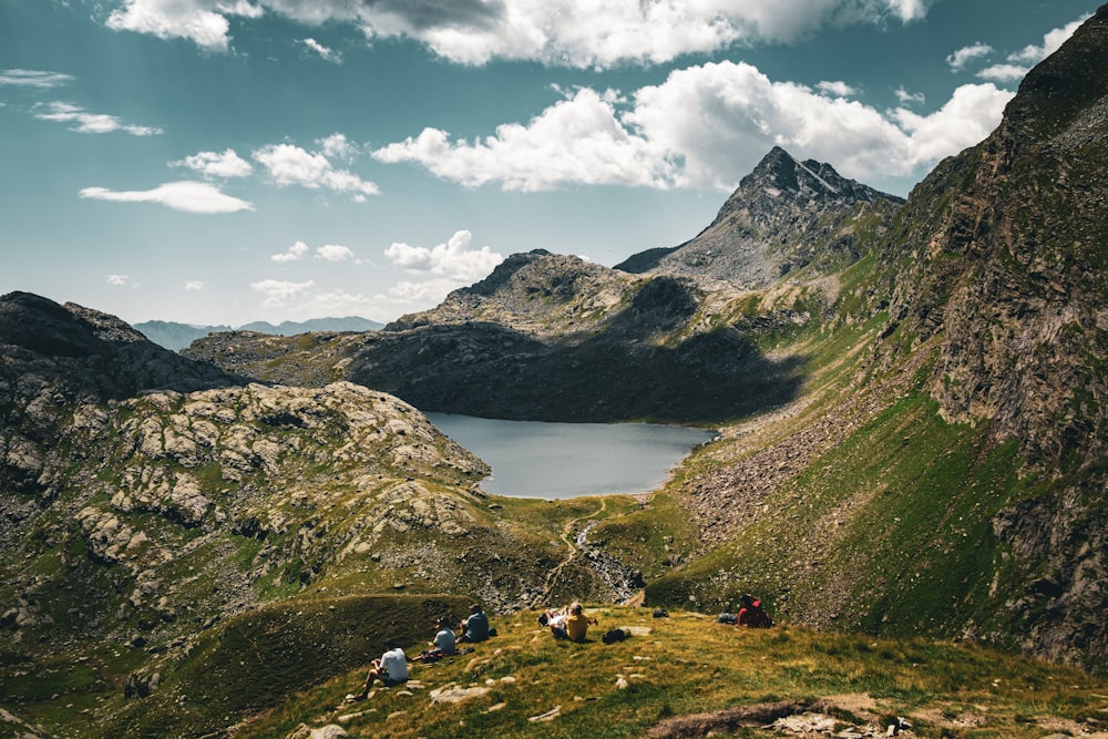 a group of people sitting on top of a mountain