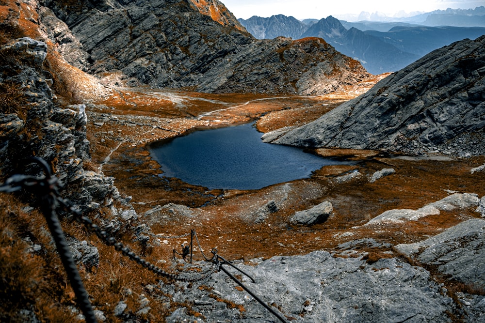 a small lake in the middle of a rocky area