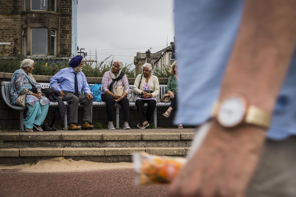 a group of elderly people sitting on a bench