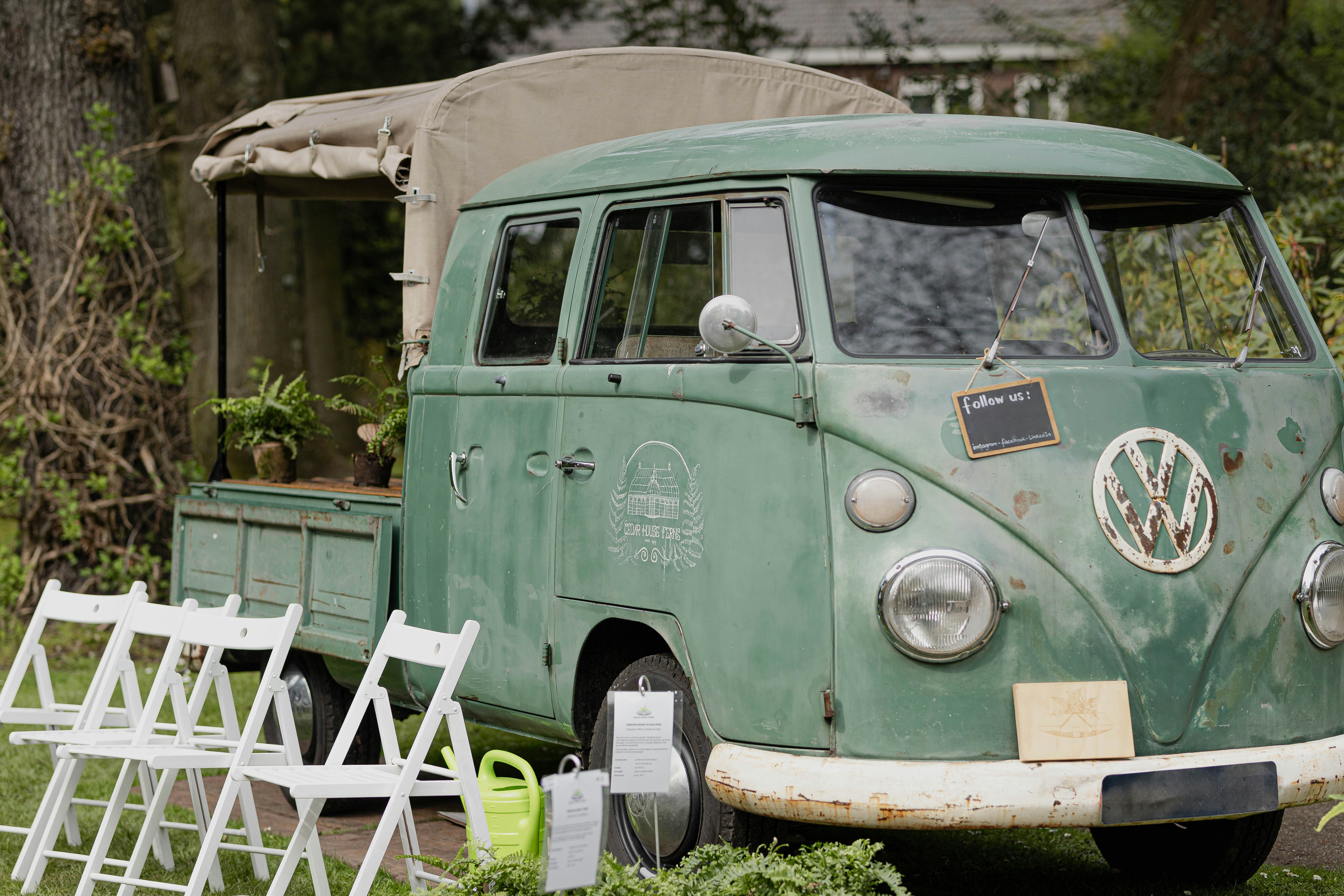 an old vw bus is parked in a field