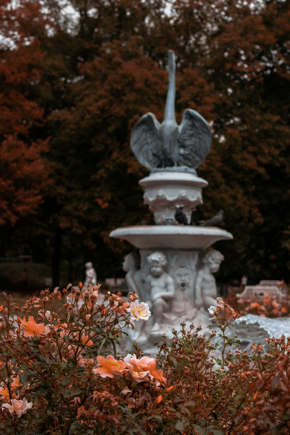a statue of a bird on top of a fountain