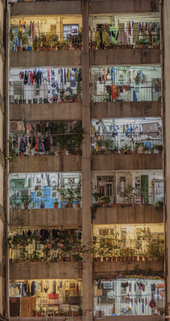 Cozy multi-family building with balconies and warm exterior lighting in the evening