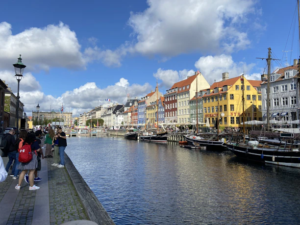 A charming canal view in Aveiro with colorful boats and traditional buildings under a bright sky.