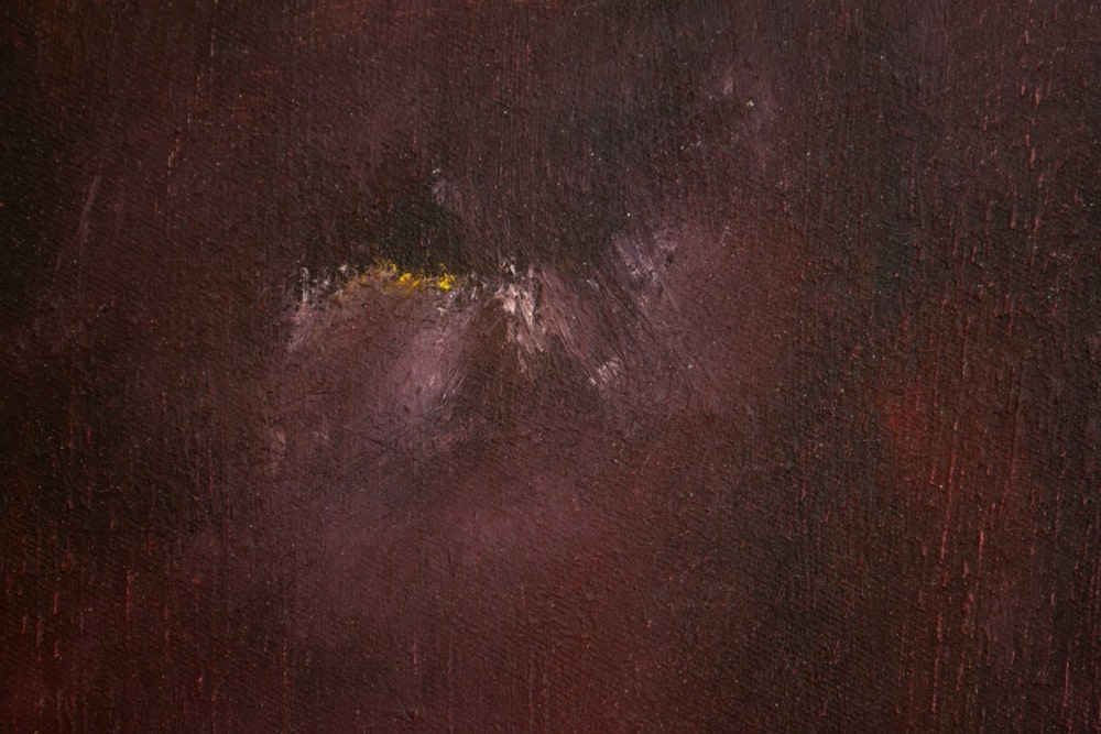 a close up of a painting with a red background